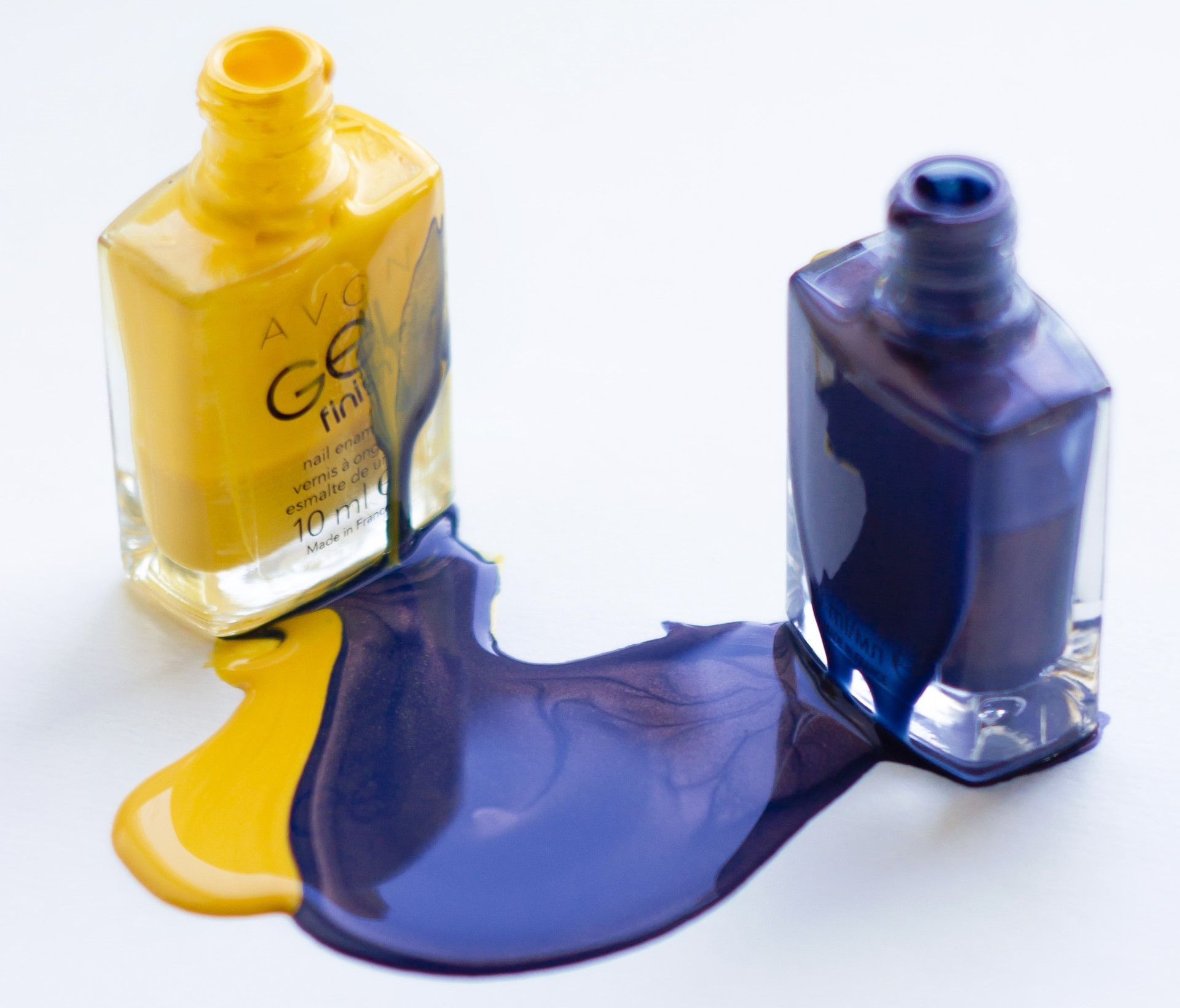 Two bottles of ink, spilling and mixing